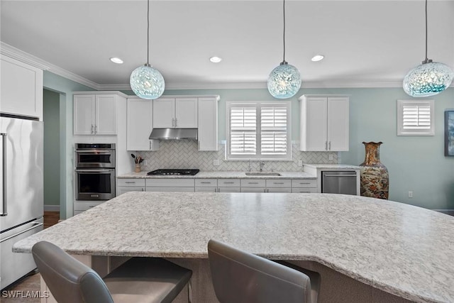 kitchen featuring white cabinetry, stainless steel appliances, and decorative light fixtures