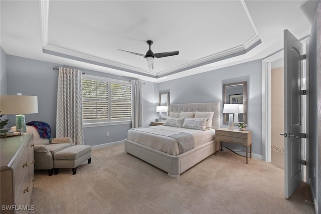 carpeted bedroom featuring ceiling fan, a raised ceiling, and crown molding