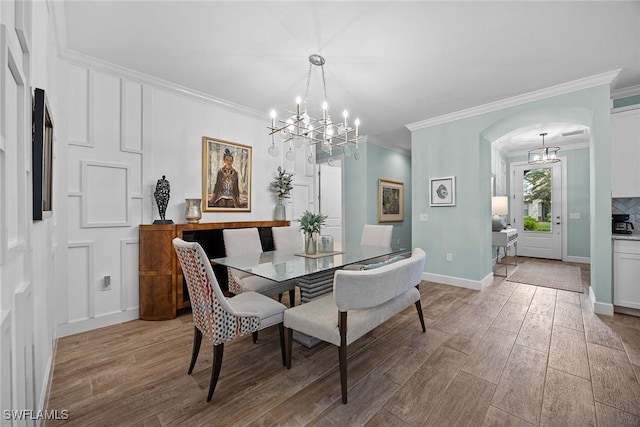 dining space with a chandelier and crown molding