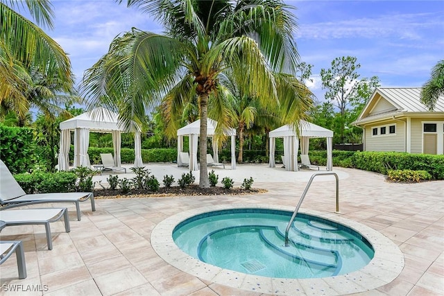 view of pool featuring an in ground hot tub, a gazebo, and a patio area