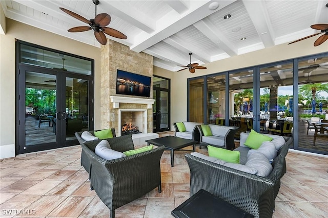 view of patio / terrace featuring an outdoor living space with a fireplace and french doors