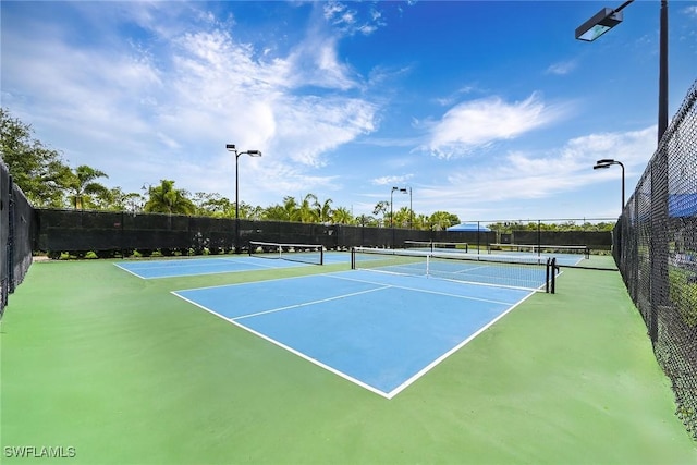 view of tennis court with basketball hoop