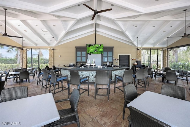 dining area featuring vaulted ceiling with beams and ceiling fan