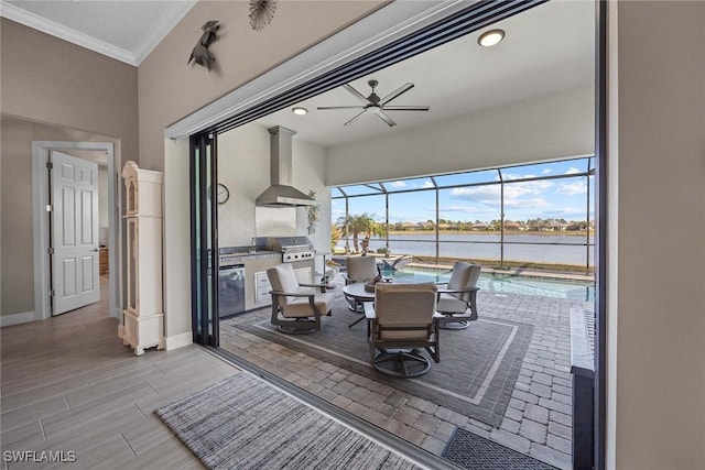 interior space with a water view, ceiling fan, and crown molding