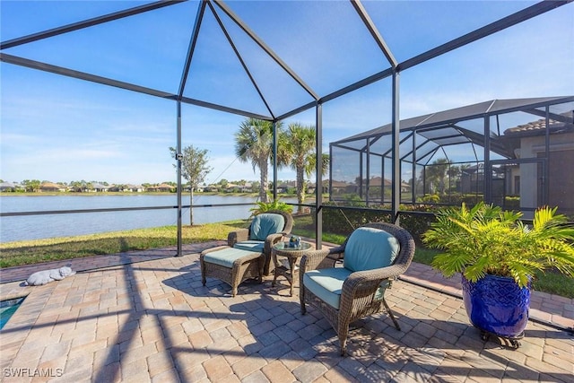 view of patio / terrace featuring glass enclosure and a water view