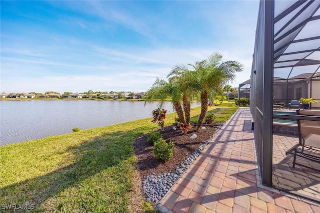 exterior space featuring glass enclosure and a water view