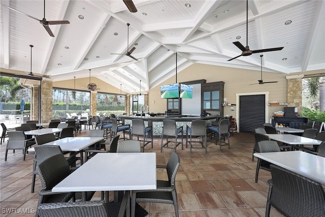 dining room with beamed ceiling, high vaulted ceiling, ceiling fan, and wooden ceiling