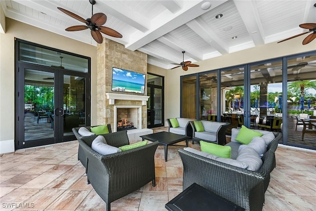 view of patio / terrace featuring an outdoor living space with a fireplace and french doors