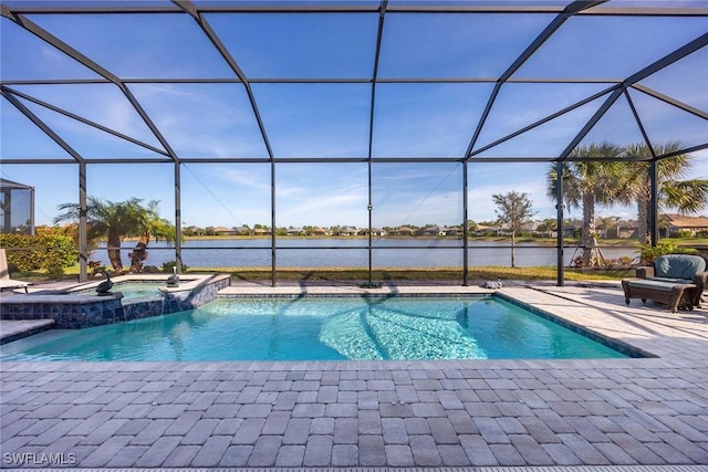 view of pool with a lanai, an in ground hot tub, and a water view