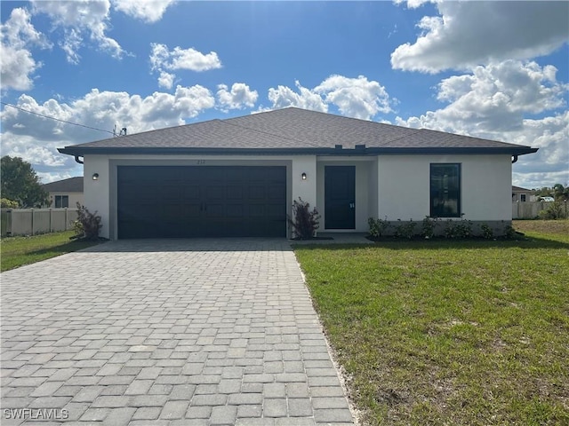 view of front of home featuring a garage and a front yard