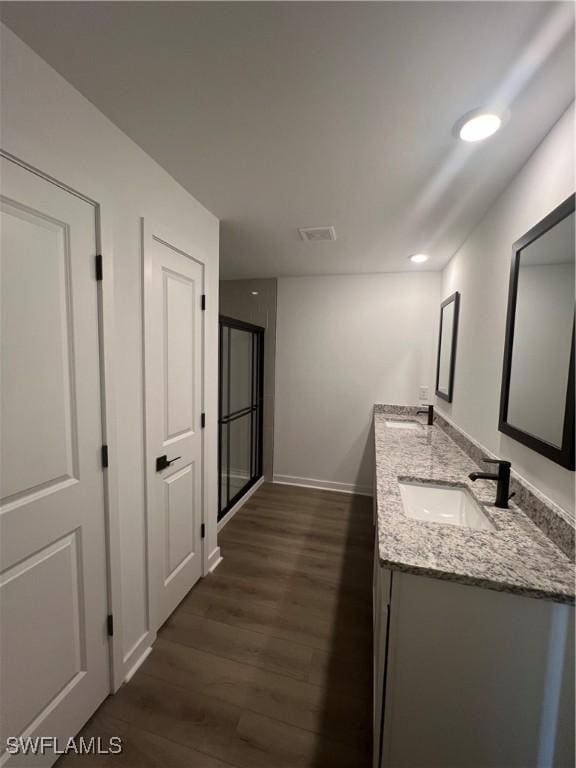 bathroom with vanity and hardwood / wood-style floors