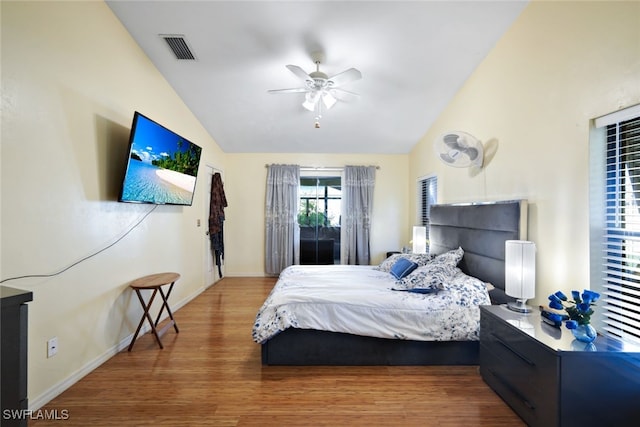 bedroom featuring ceiling fan, wood-type flooring, and lofted ceiling