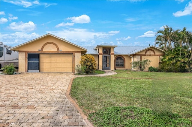 single story home featuring a front yard and a garage