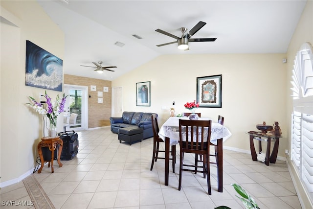 tiled dining room featuring ceiling fan and vaulted ceiling