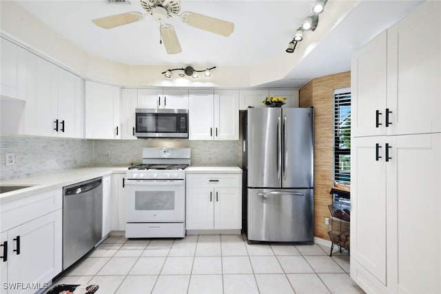 kitchen with light tile patterned floors, stainless steel appliances, and white cabinetry