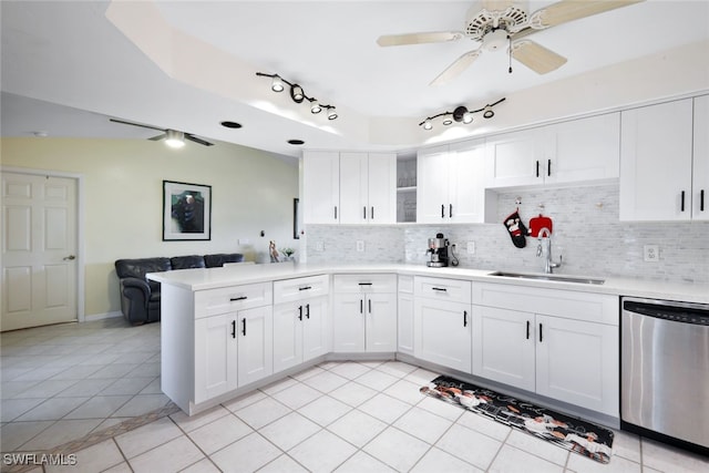 kitchen featuring tasteful backsplash, sink, white cabinets, and stainless steel dishwasher