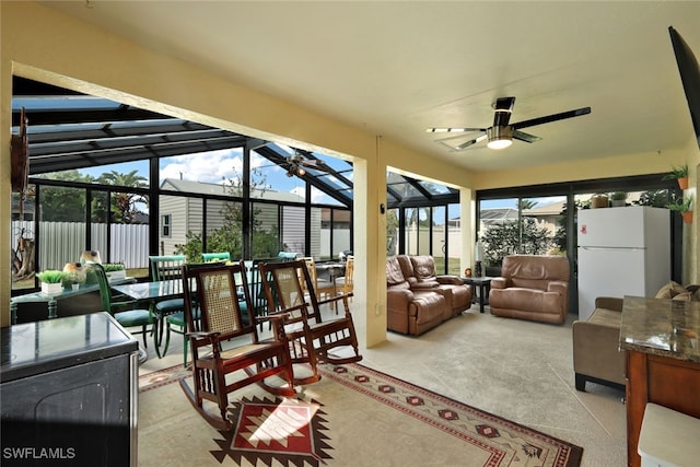 sunroom featuring ceiling fan, plenty of natural light, and lofted ceiling