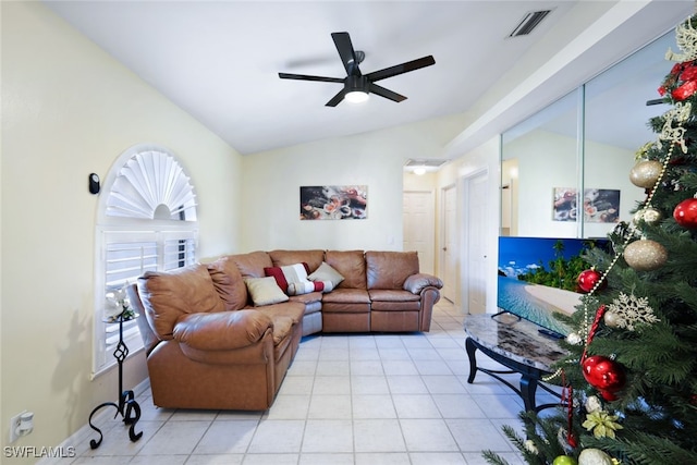 living room with light tile patterned floors, ceiling fan, and lofted ceiling