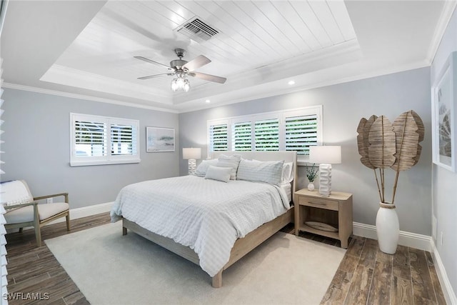 bedroom with a raised ceiling, ceiling fan, and crown molding