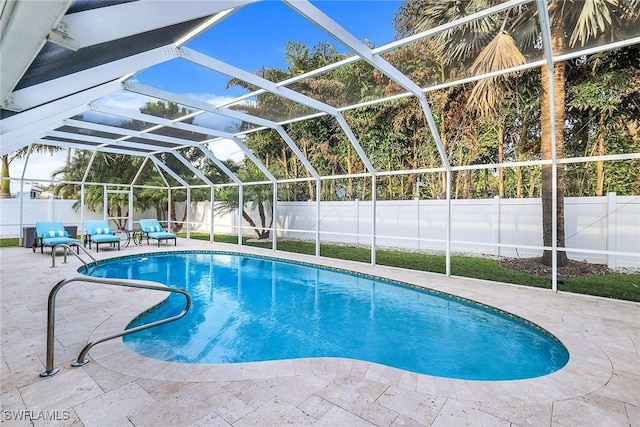 view of pool featuring glass enclosure and a patio