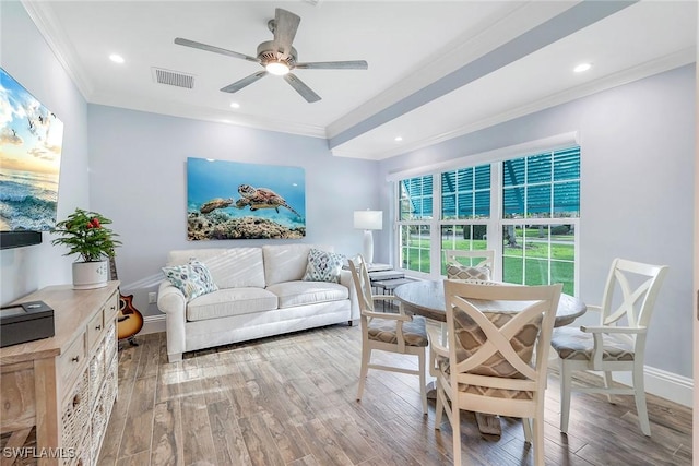 living room featuring wood-type flooring, ceiling fan, and crown molding