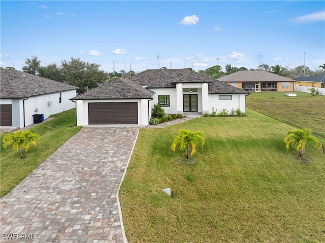 view of front facade with a front yard and a garage