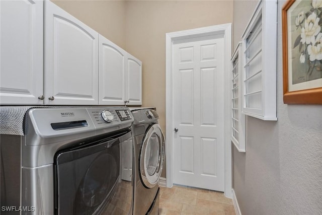 clothes washing area with cabinets and independent washer and dryer