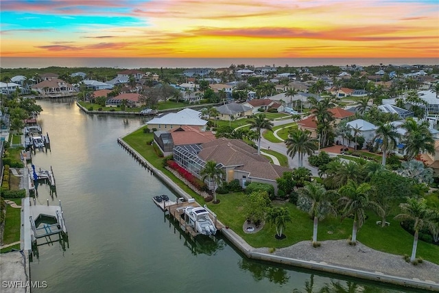 aerial view at dusk with a water view