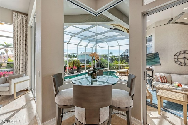 sunroom featuring a wealth of natural light and a pool