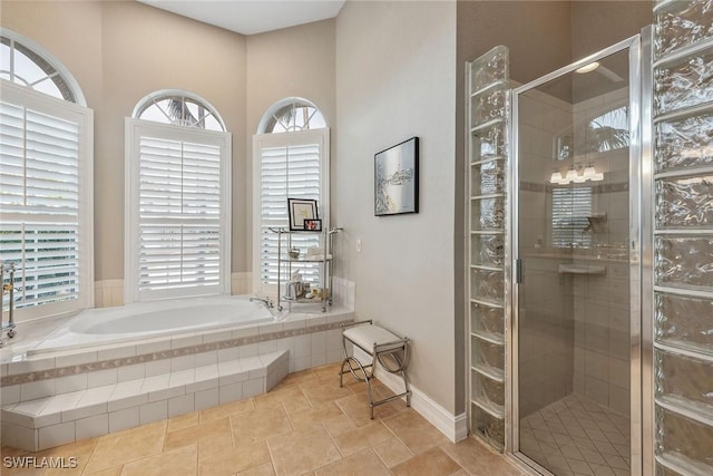 bathroom featuring shower with separate bathtub