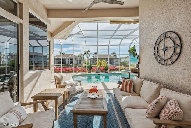 view of pool with a lanai, outdoor lounge area, ceiling fan, and a patio area