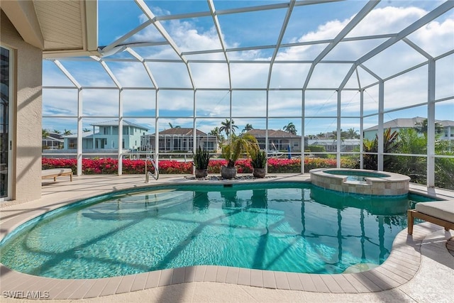 view of pool with a patio area, a lanai, and an in ground hot tub