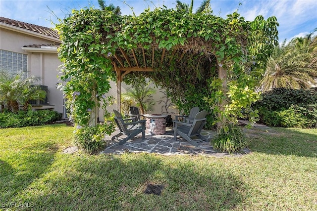 view of yard featuring a fire pit, a patio area, and a pergola