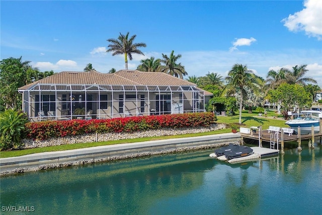 rear view of house featuring a water view and a lanai