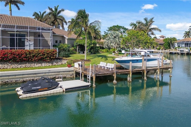 view of dock with a lanai, a yard, and a water view