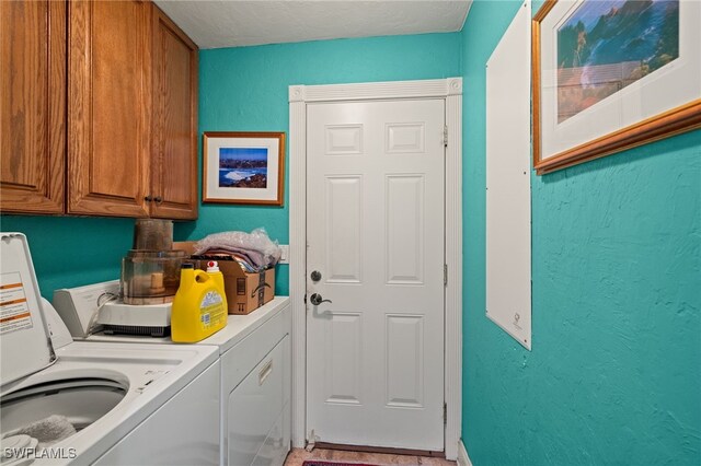 laundry area featuring cabinets and washing machine and dryer