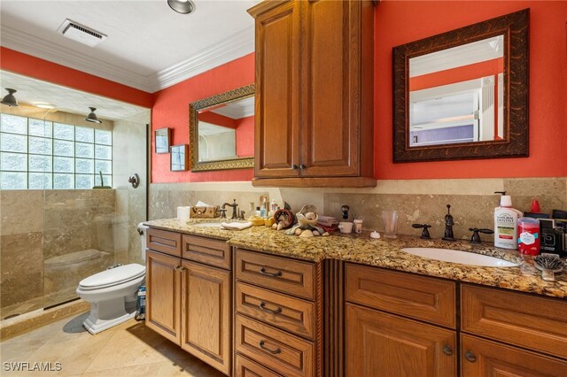 bathroom featuring vanity, tile patterned floors, crown molding, toilet, and tiled shower