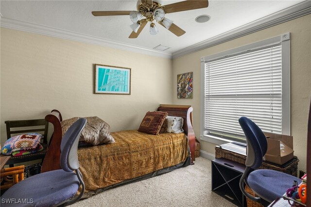 carpeted bedroom featuring ceiling fan and crown molding