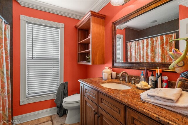 bathroom featuring toilet, tile patterned flooring, vanity, and ornamental molding