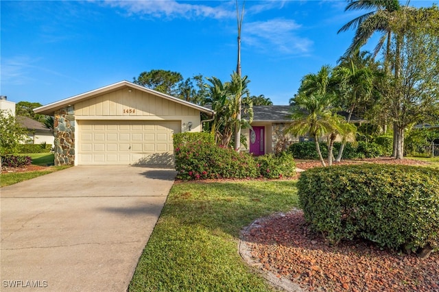 ranch-style house featuring a front yard and a garage