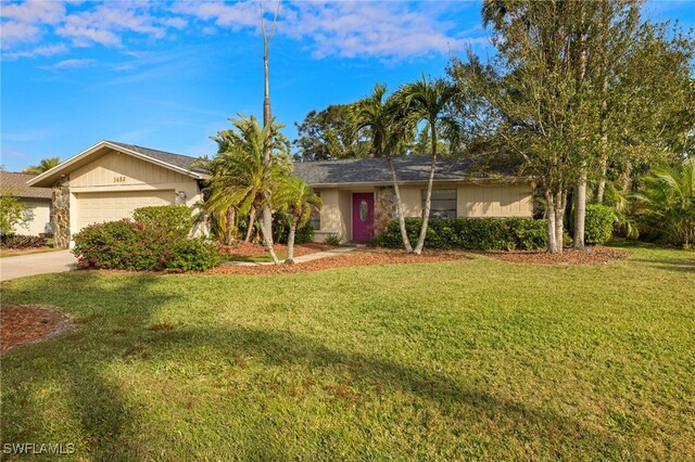 ranch-style house with a front lawn and a garage