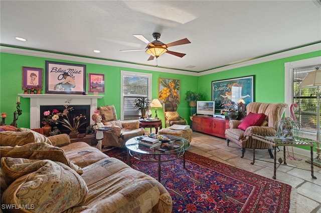 living room with ceiling fan and ornamental molding