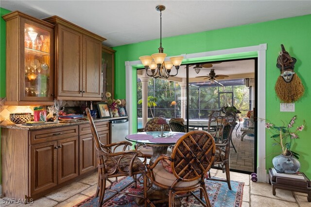 dining area with ceiling fan with notable chandelier