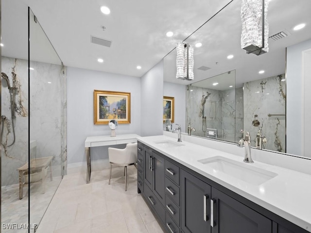 bathroom featuring a tile shower and vanity