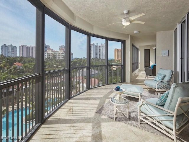 sunroom / solarium featuring ceiling fan