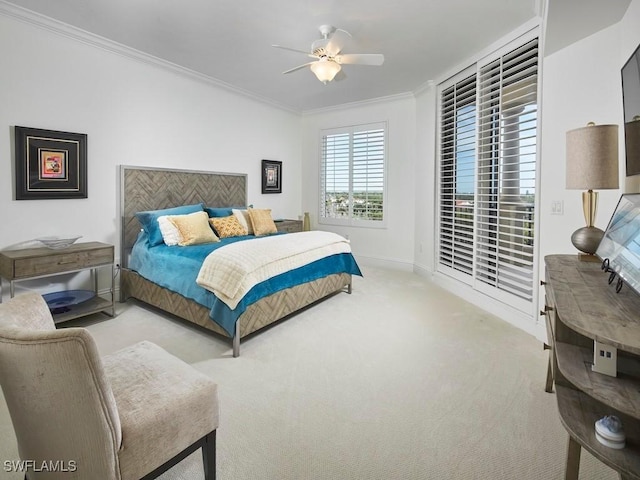 bedroom featuring ceiling fan, light colored carpet, and crown molding