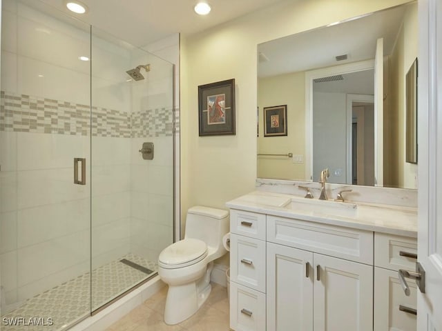 bathroom with tile patterned flooring, vanity, toilet, and a shower with shower door