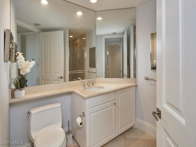 bathroom with tile patterned flooring, toilet, a shower, and vanity