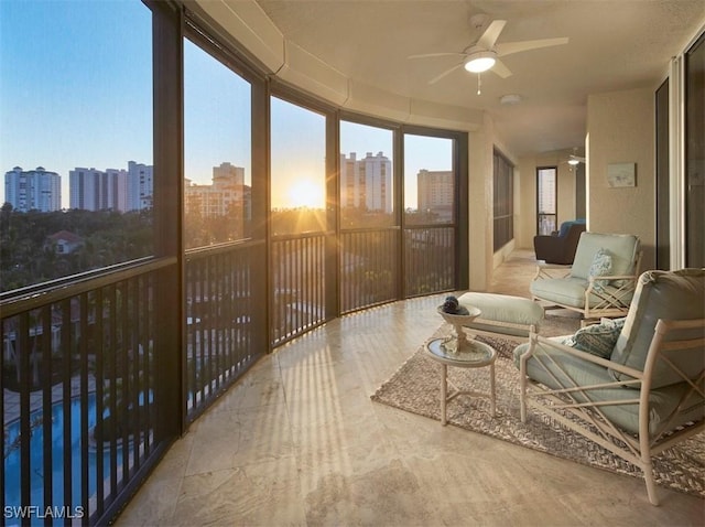 sunroom / solarium featuring ceiling fan