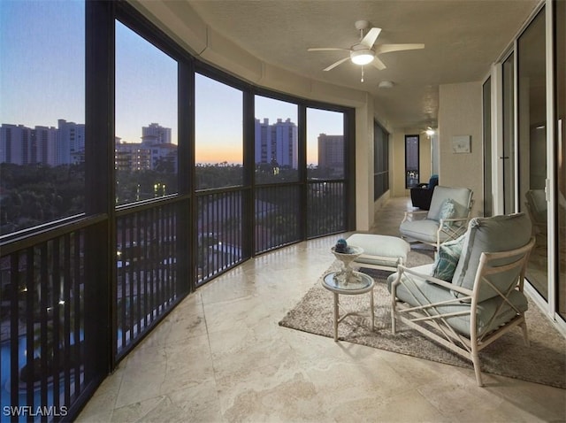 sunroom featuring ceiling fan